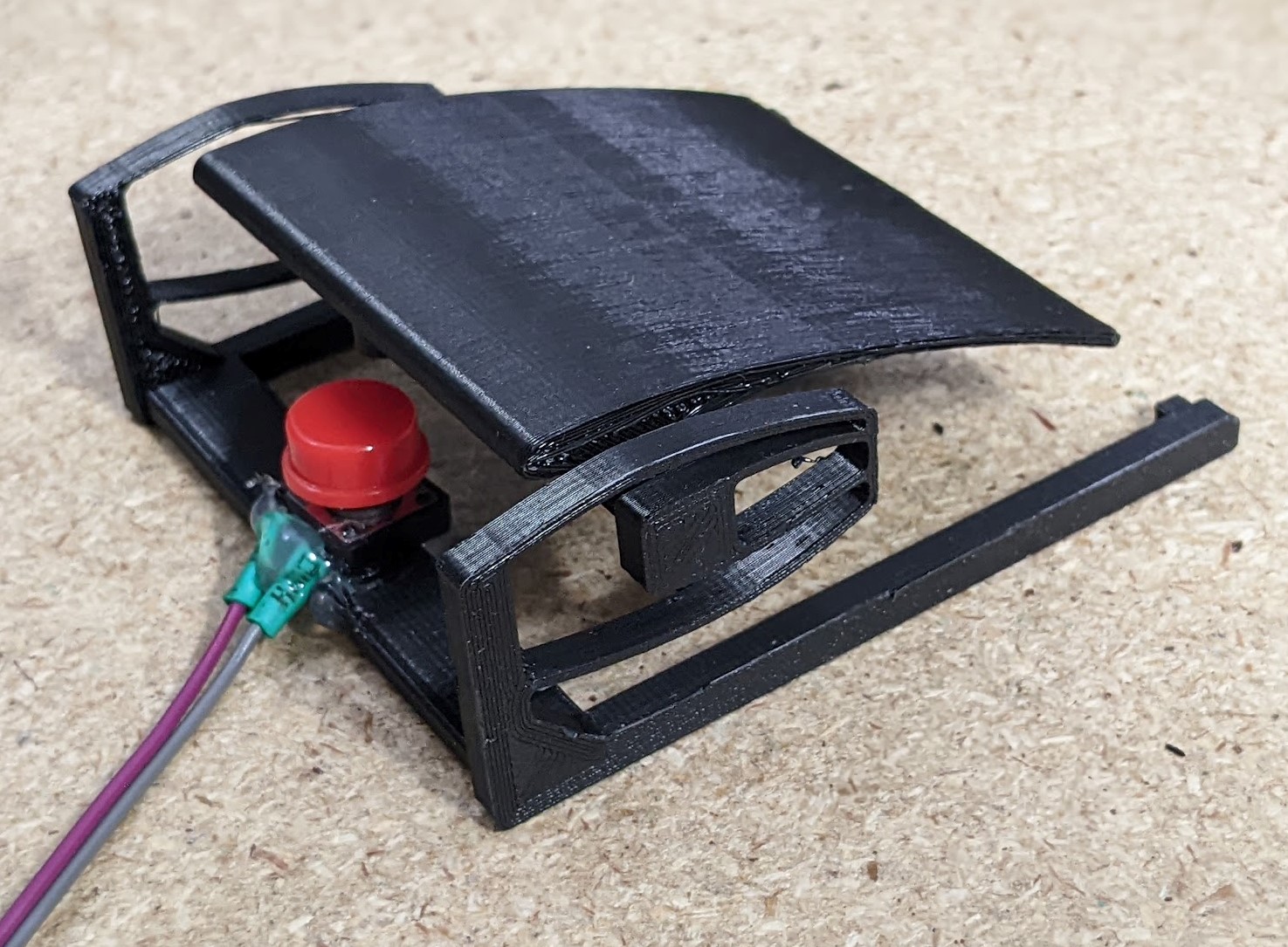 The final printed pedal, with a tactile button hot glued in place.